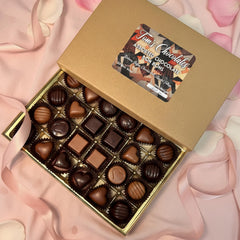 Nut-filled hazelnut and almond bonbons close-up with glossy chocolate shells