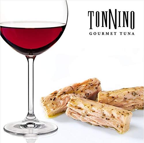 Tonnino Tuna Ventresca in Oil with oil drizzle over plate for versatile topping