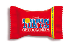 Tony's Chocolonely Tiny Tony's milk chocolate bites closeup – creamy texture and inviting aroma.