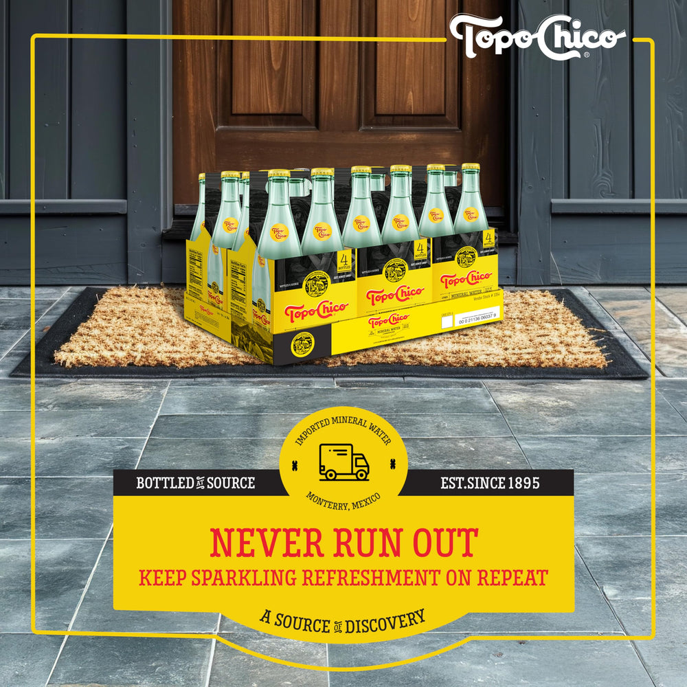Topo Chico Sabores Tangerine Ginger can resting on ice with bubbles.
