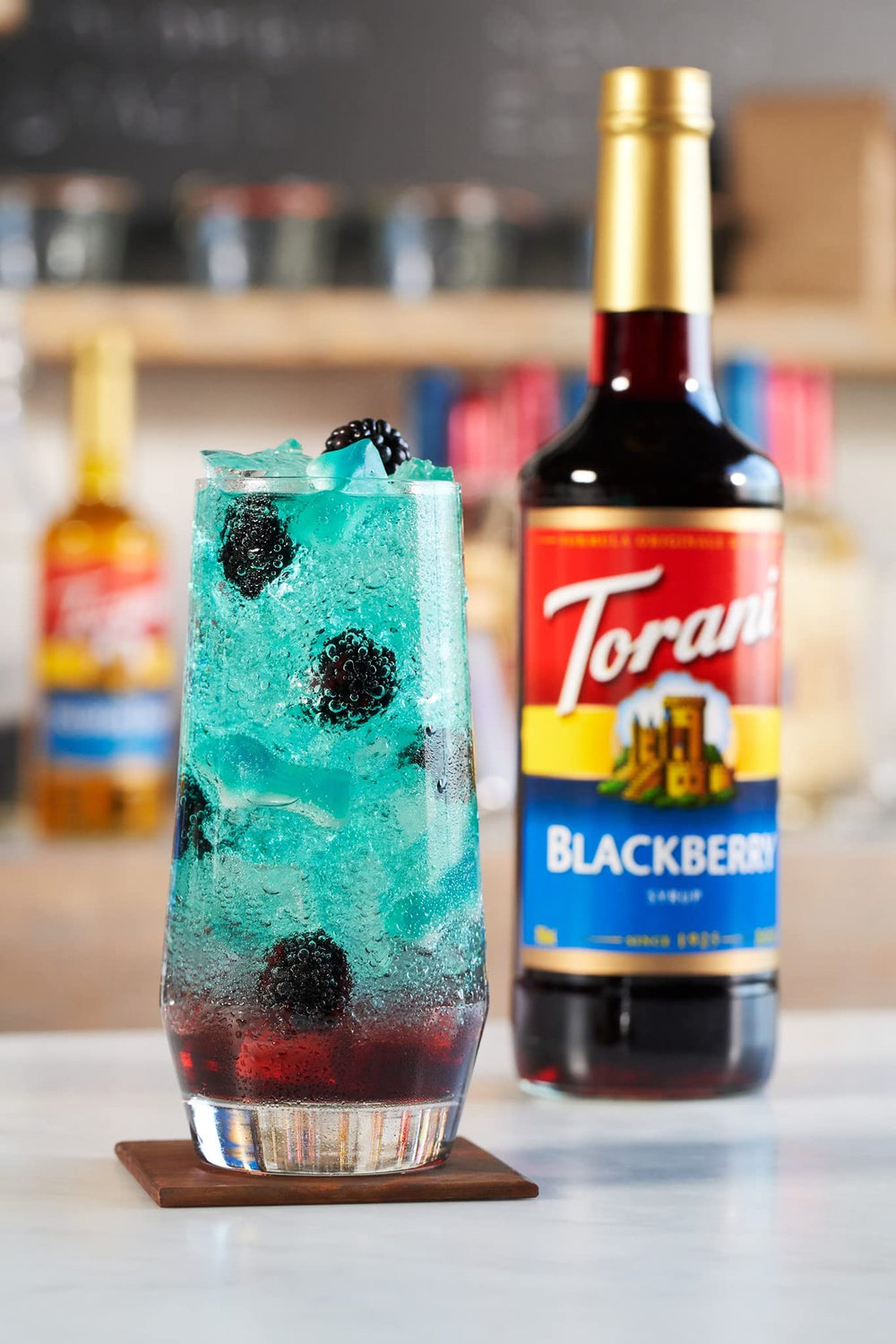 Torani Blackberry Syrup stirred into a sparkling soda for refreshment