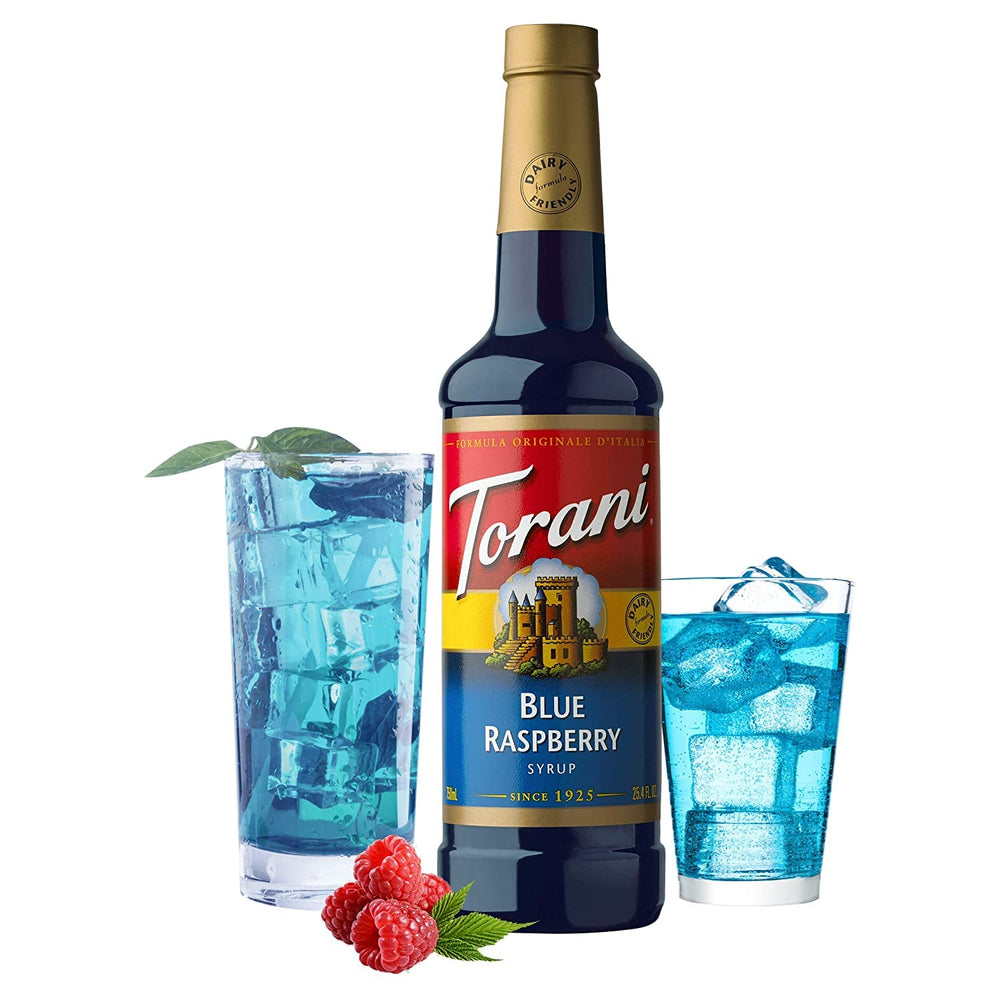 Torani Blue Raspberry bottle beside espresso cup for coffeehouse-inspired beverage.