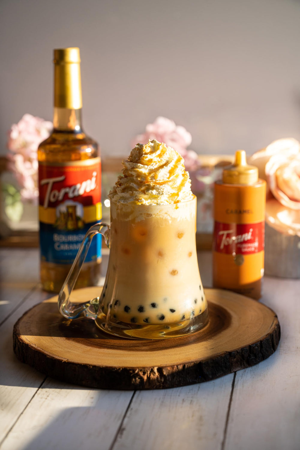 Pouring Torani Bourbon Caramel Syrup to enhance a drink