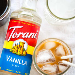 Torani Caramel Syrup bottle pour adds rich caramel notes to coffee and mochas.