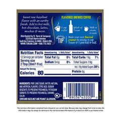 Pouring Torani Hazelnut syrup enhances coffee with a nutty aroma.