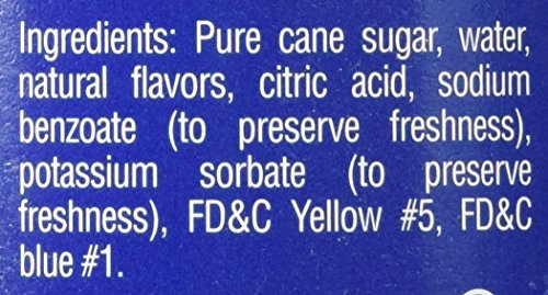 Torani Creme De Menthe syrup bottle angled for layered beverages and fizz.
