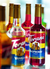 Torani Hazelnut Syrup in amber bottle highlights easy-pour convenience for hot drinks.
