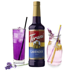 Glass Torani Lavender Syrup bottle on a cafe counter, ready for specialty drinks.