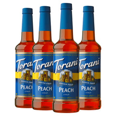 Torani Sugar Free Peach syrup bottle pouring for fruity, sugar-free flavor.