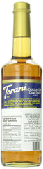 Torani syrup bottle beside an espresso cup on a kitchen counter
