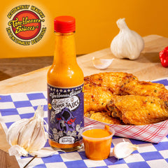 Dramatic drizzle of Torchbearer Garlic Reaper sauce over a dish