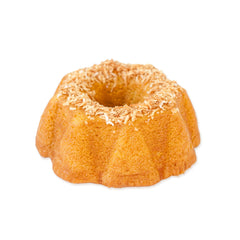 TORTUGA coconut rum cake slice tilted to show moist texture.