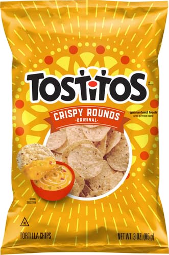 Backyard barbecue scene featuring Tostitos Crispy Rounds as a snack option.