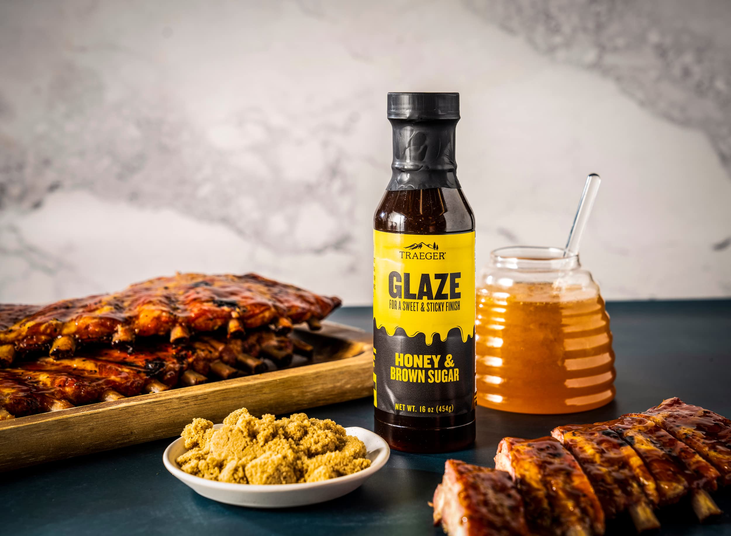 Traeger Honey Brown Sugar Glaze bottle with serving suggestion