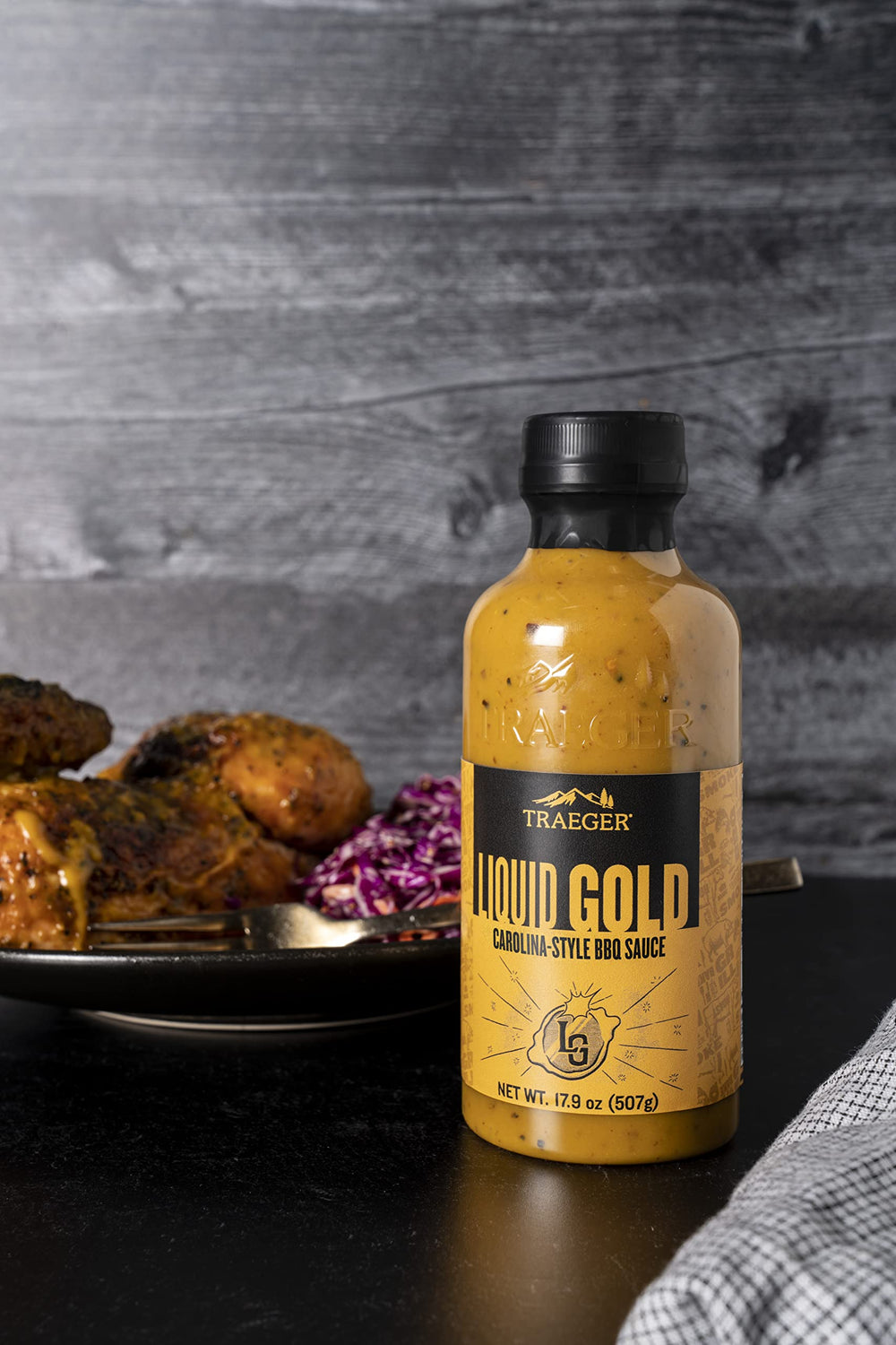 Pouring Traeger Liquid Gold BBQ Sauce creates a glossy glaze.
