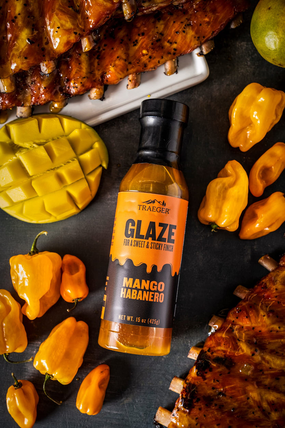 Traeger Mango Habanero Glaze on pork creates a sticky glaze with mango sweetness