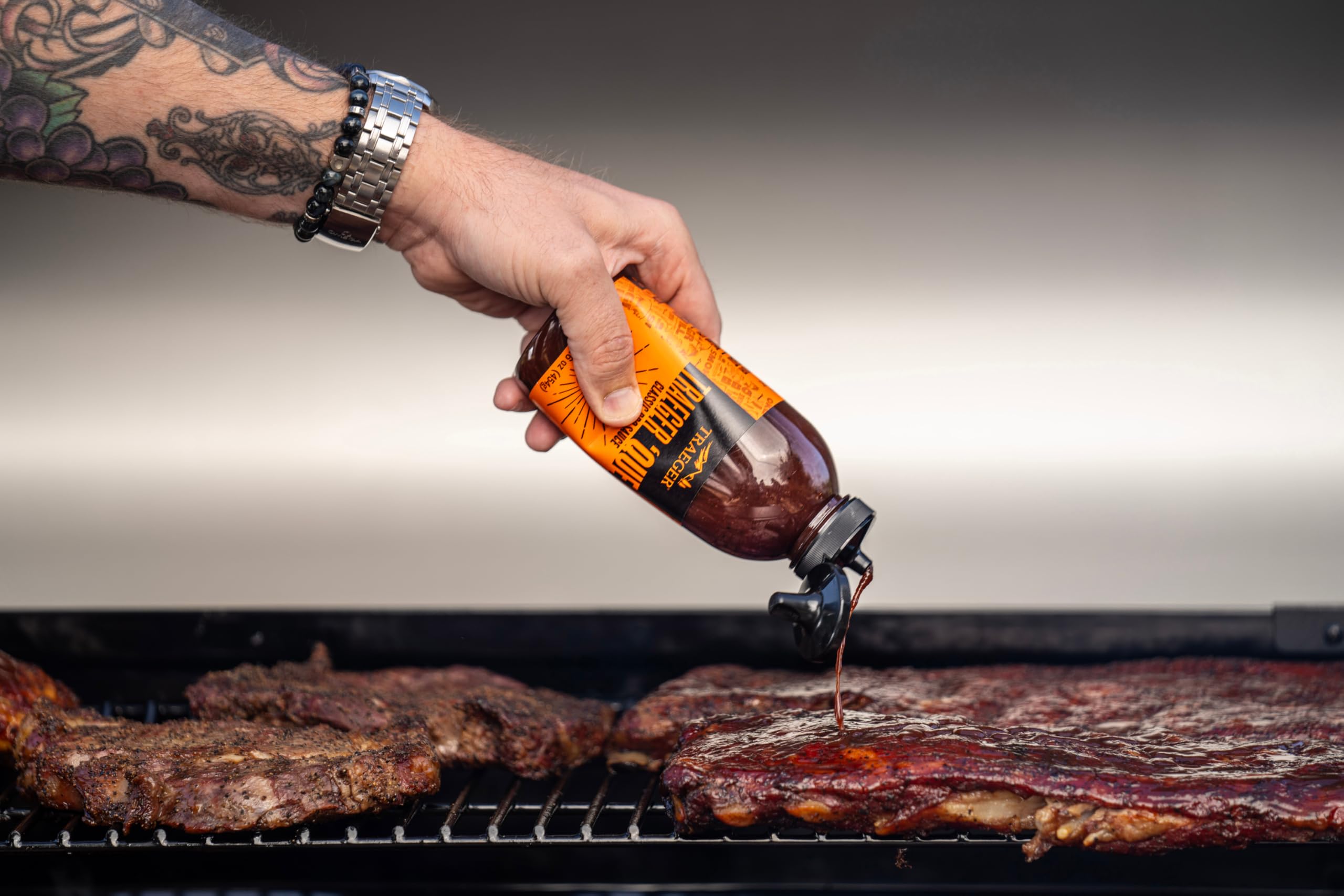 Traeger Que BBQ Sauce on a dinner plate boosts homemade flavor.