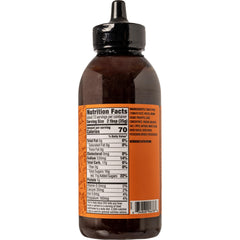 Pouring Traeger Que BBQ Sauce to boost smoky-sweet BBQ flavor.