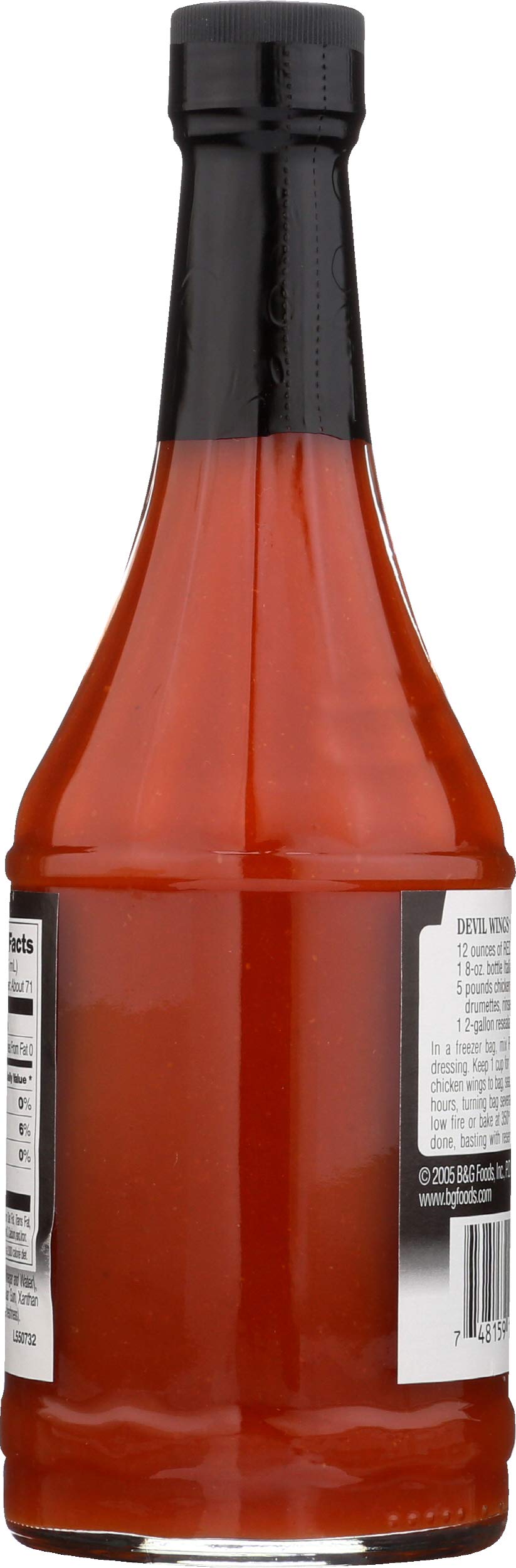 Pouring Trappey's Red Devil Sauce highlights vibrant heat for wings and sandwiches