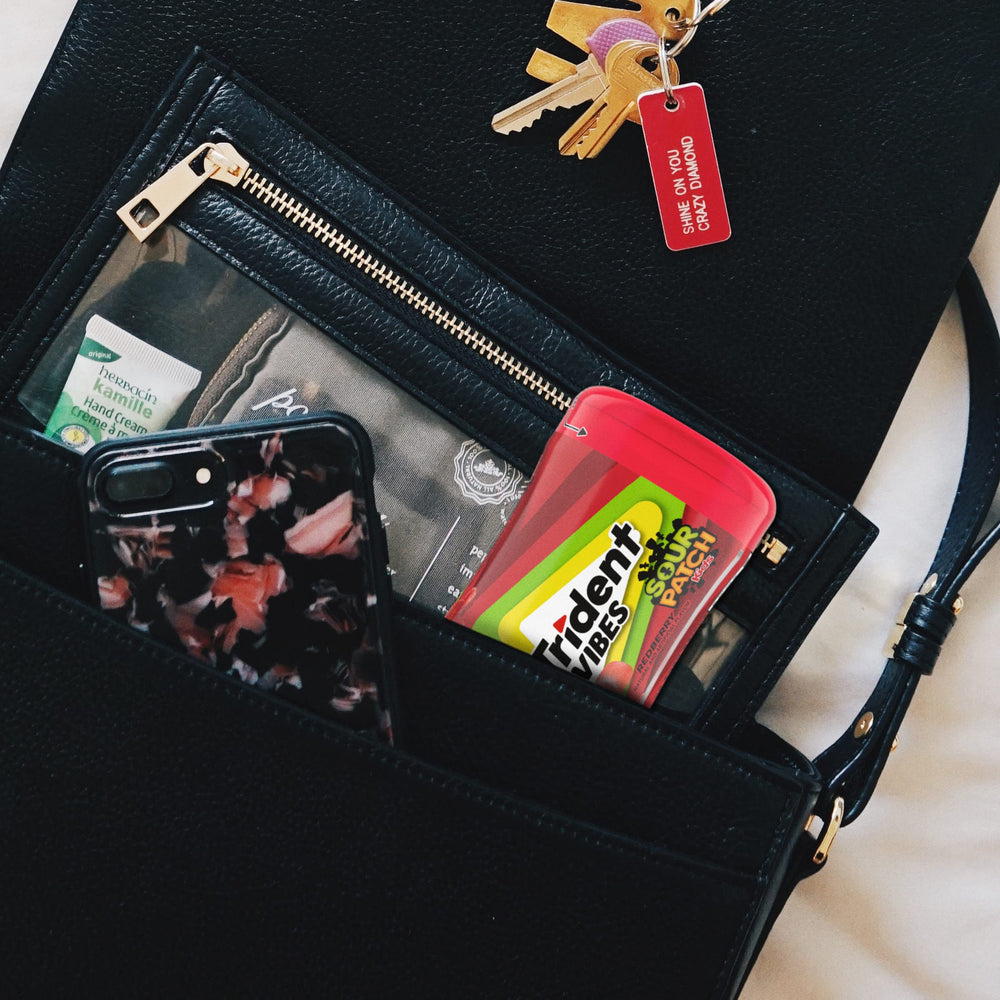 Trident Vibes Sour Patch Kids Redberry gum on desk for quick refresh.