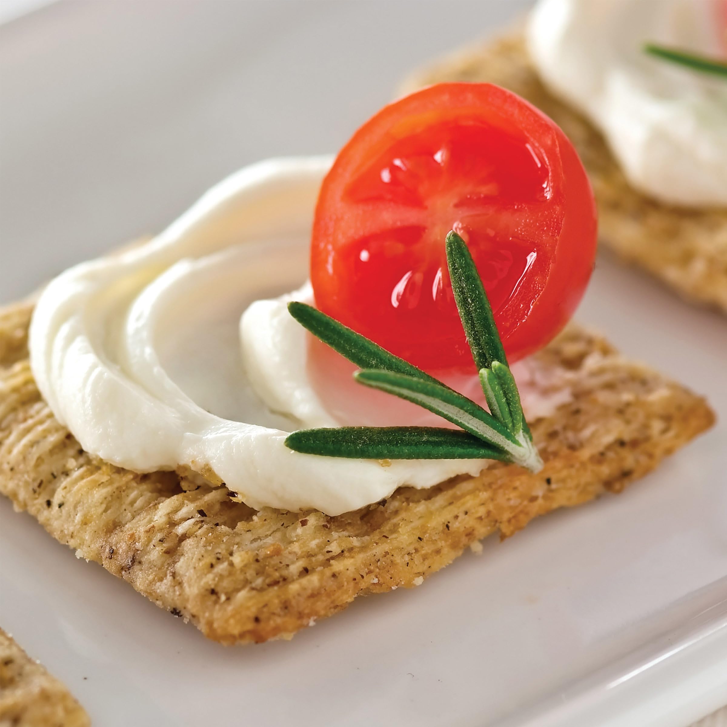 Triscuit crackers on a party platter with dips and meats.