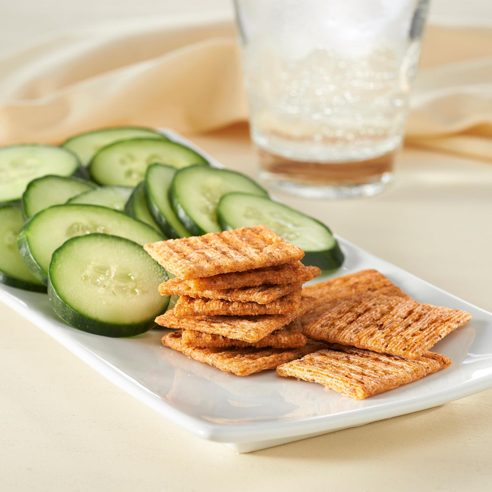 Triscuit Reduced Fat Whole Grain crackers family box shows shelf-stable pantry snack.