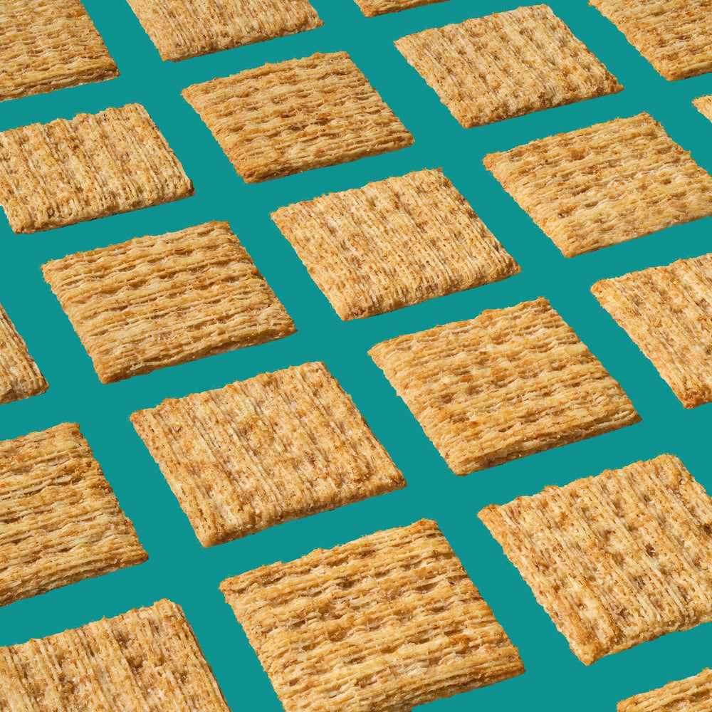 Triscuit Reduced Fat Whole Grain crackers close-up reveals crunchy woven texture for toppings.