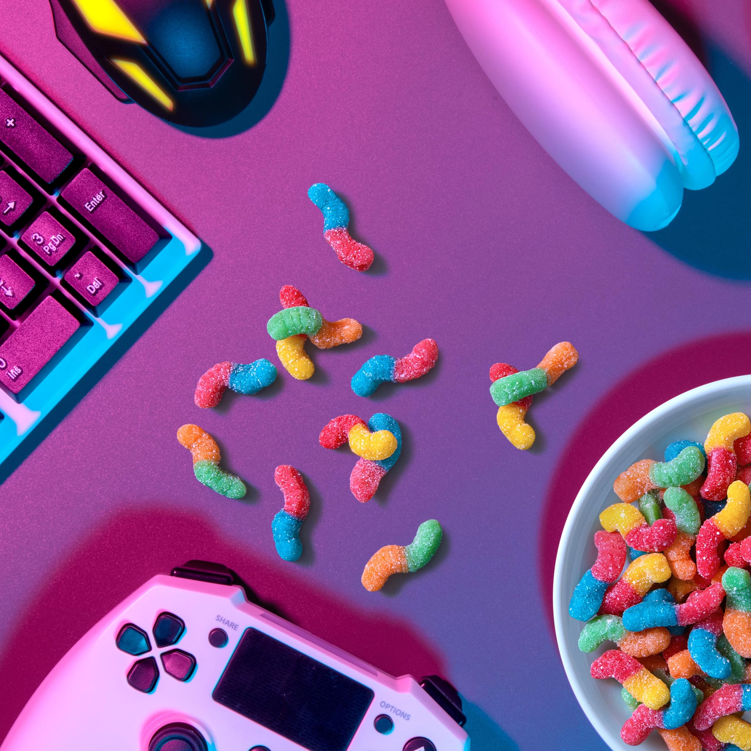 Party bowl spread with colorful worms and bright snacks.
