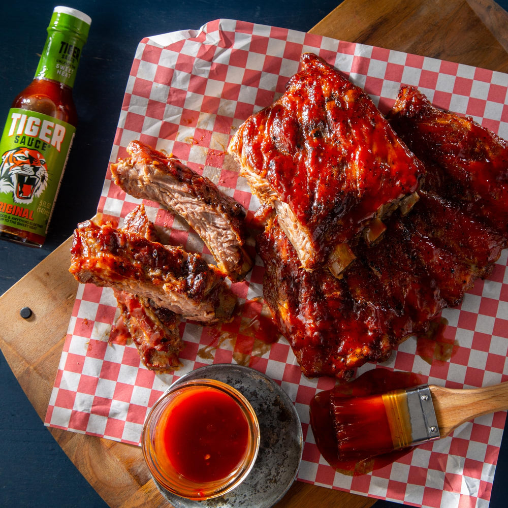 Try Me Tiger Sauce Original meat dish shot highlighting bold sweet heat on proteins