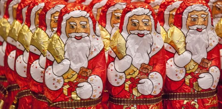Lindt Milk Chocolate Santa figures arranged for gift table displays.
