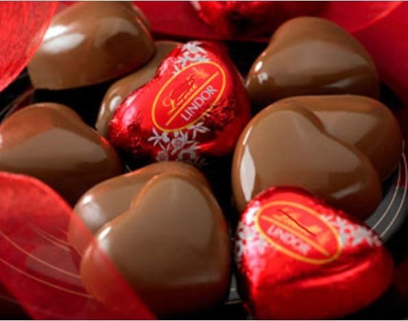 Tundras Valentines Day milk chocolate heart closeup, creamy center revealed for tasting.