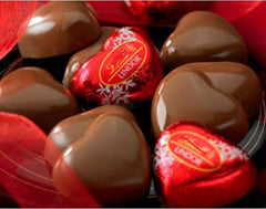 Tundras Valentines Day milk chocolate heart closeup, creamy center revealed for tasting.