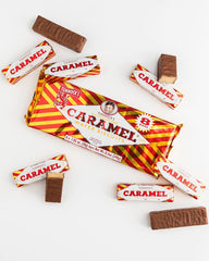 Tunnock's real milk chocolate caramel wafer close-up highlighting smooth chocolate and golden caramel.