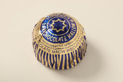 Tunnock's Tea Cakes dark chocolate coating close-up, highlighting rich chocolate finish.