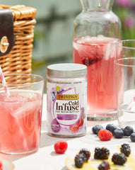 Glass of Twinings Cold Infuse iced tea with vibrant berry color.