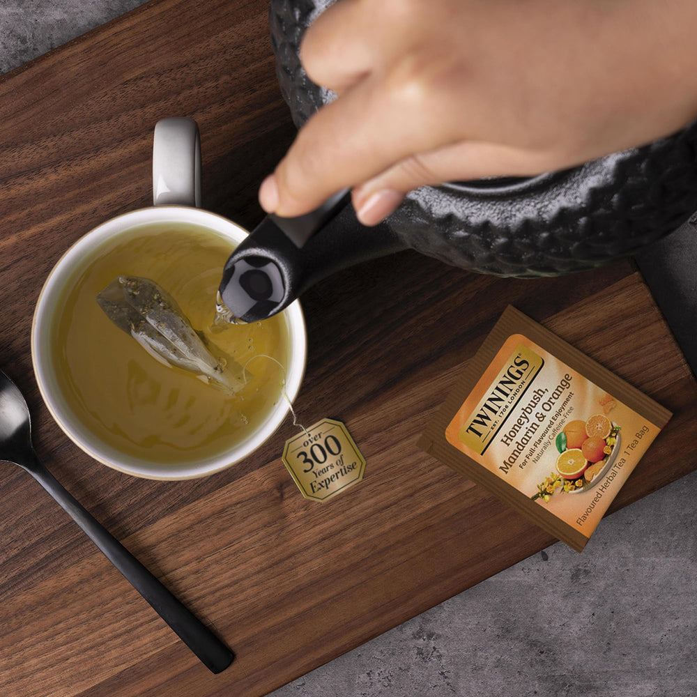 Twinings Honeybush Mandarin Orange aroma cup, steam rising with citrus hints and herbal sweetness.