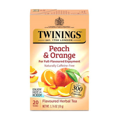 Twinings peach-orange herbal tea bags on a counter; caffeine-free, inviting aroma.
