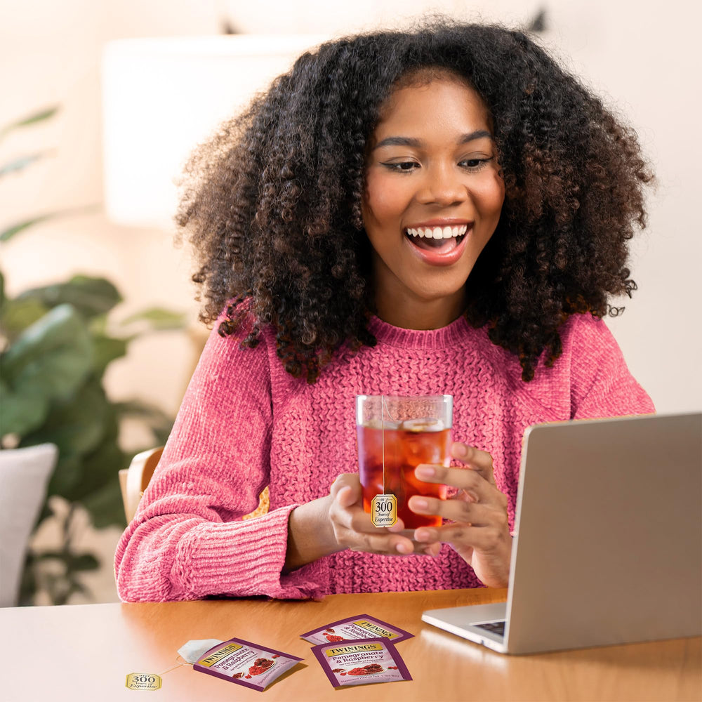 Steaming Twinings Pomegranate & Raspberry cup shows a bold fruity aroma.