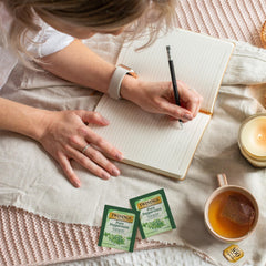 Hot brew from Twinings Pure Peppermint tea releasing soothing mint flavor.