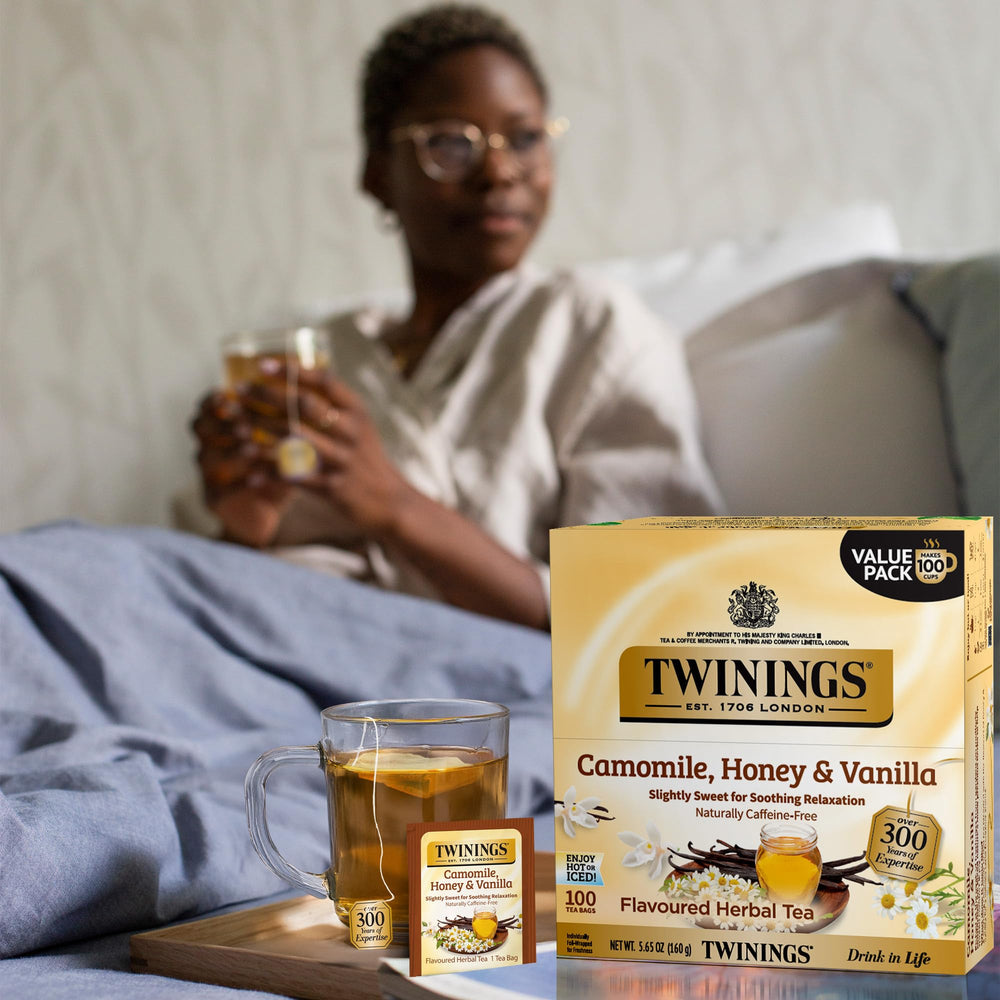 Close-up of a Twinings tea bag releasing aroma in hot water.