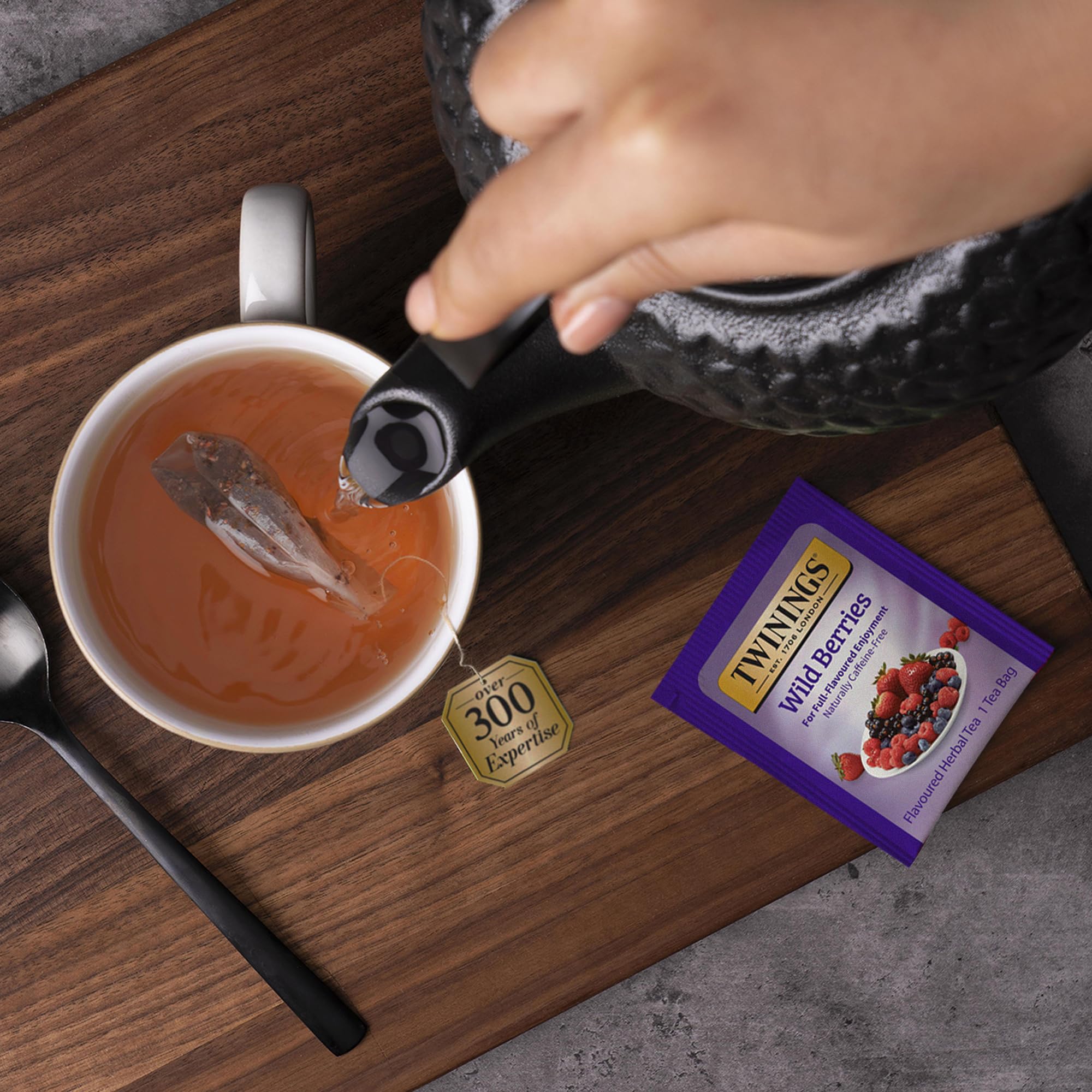 A warm cup of Twinings Wild Berries offers a fragrant, caffeine-free evening ritual.