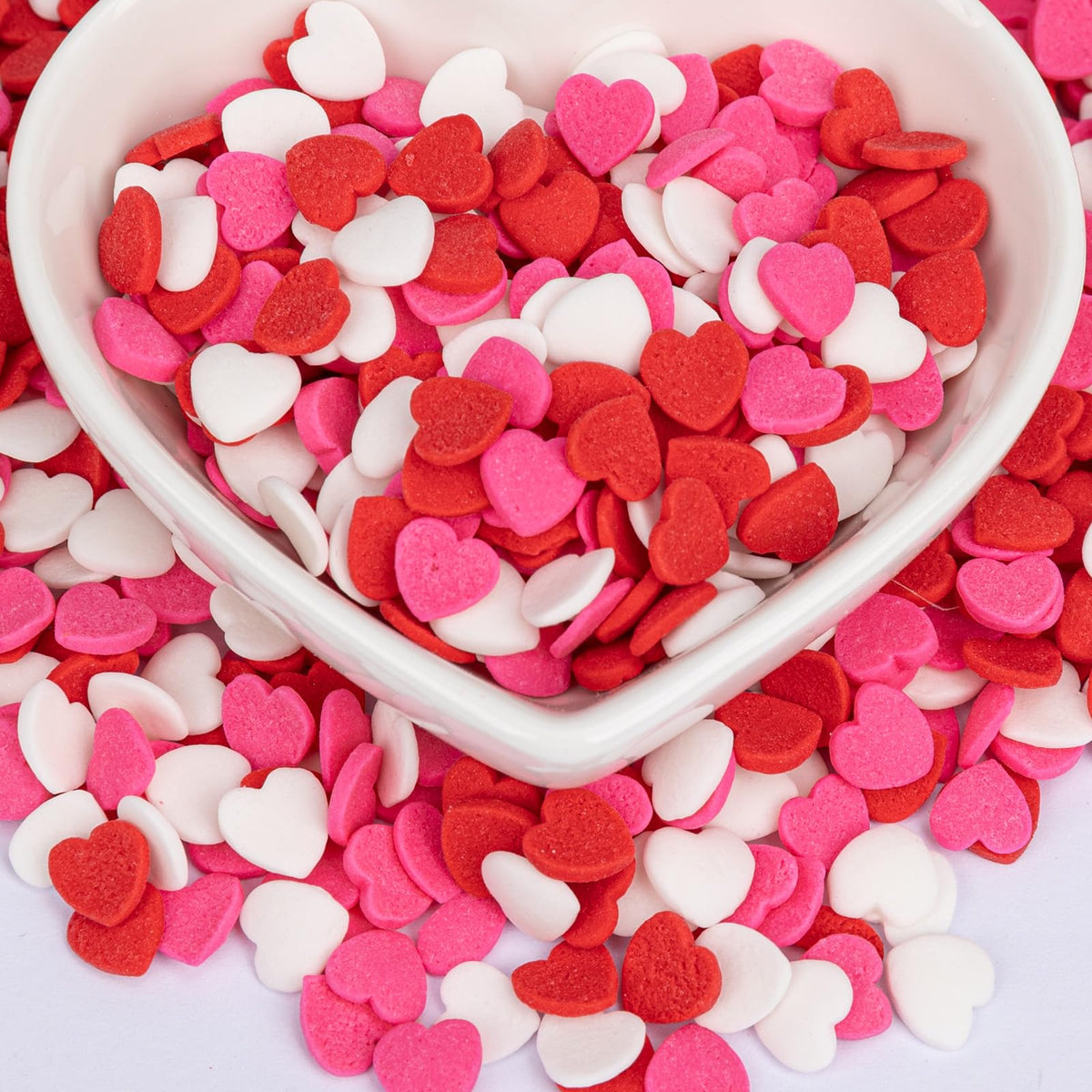 Twisweet heart sprinkles jar closeup for vibrant pink, red, and white cake decoration.