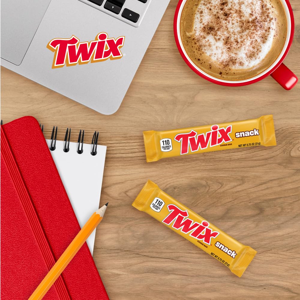 Gold-wrapped Twix beside a coffee cup, suggesting afternoon pairing.