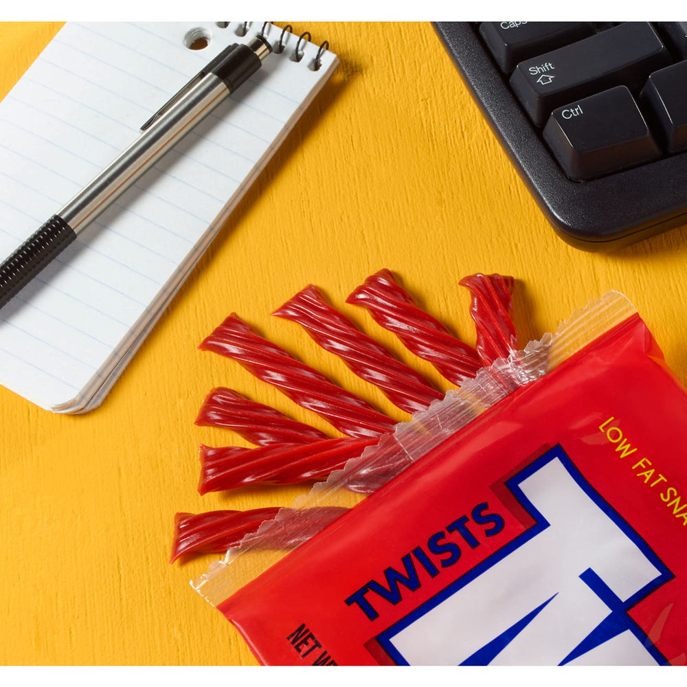 Dipping Twizzlers Twists strawberry into milk or hot chocolate.