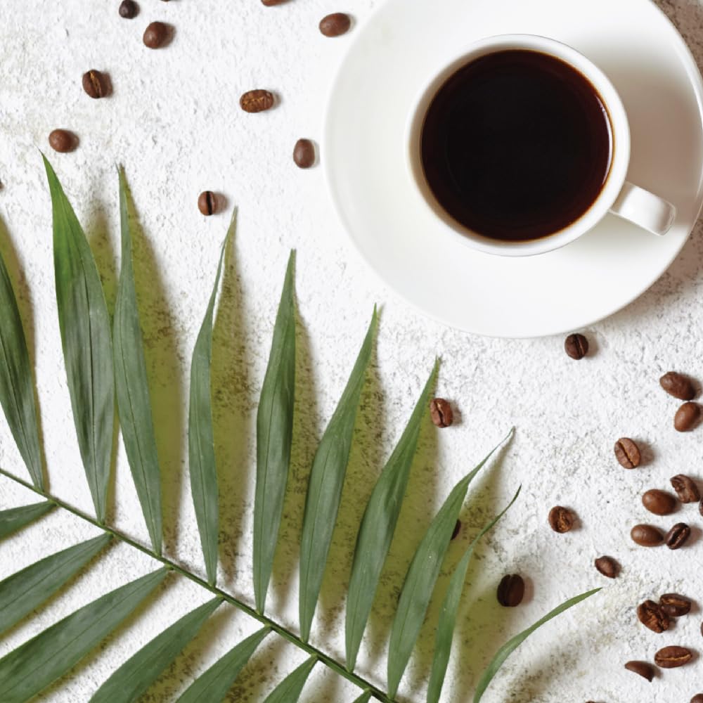 Two Rivers Chocolate Coconut ground coffee being poured into a filter for drip coffee.