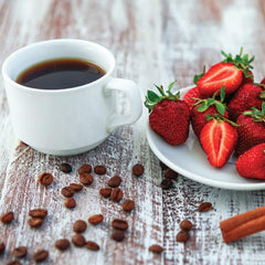 Two Rivers Coffee Strawberries N Cream cup with steam signaling inviting fruity aroma.
