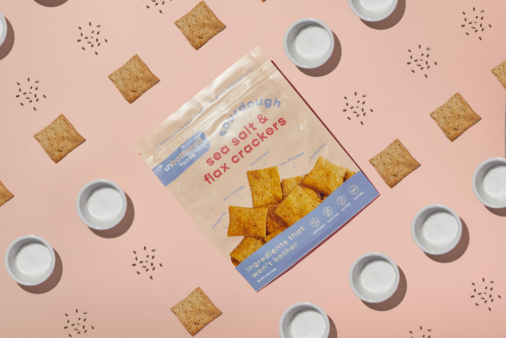 Dipping Unbothered Foods sourdough crackers in honey for contrast.