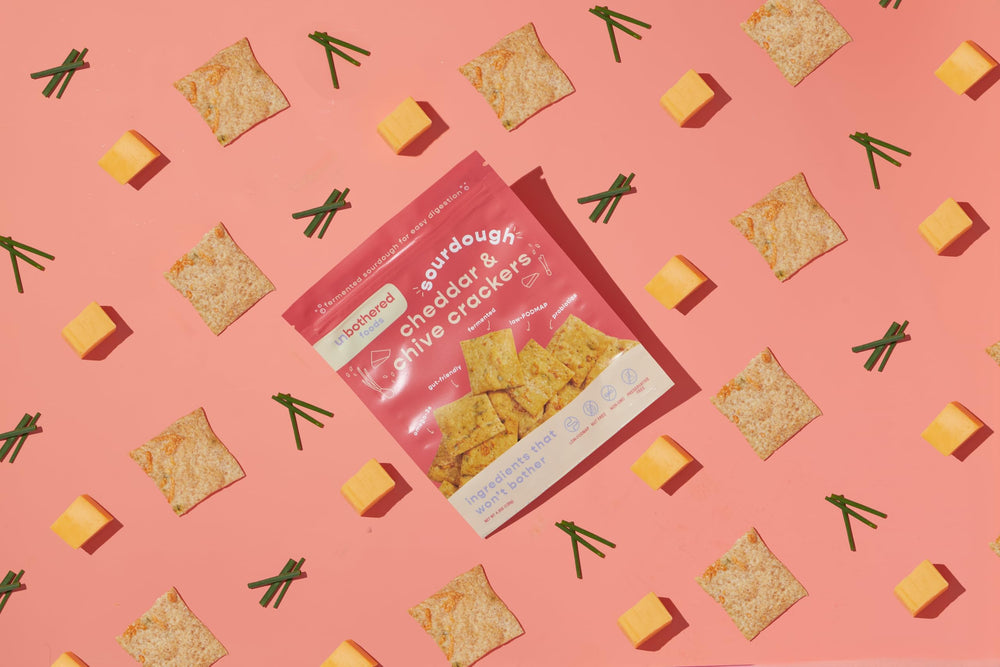 Crackers from Unbothered Foods in a rustic wood bowl.