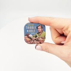 Side view of the mint tin beside a bag for easy access.