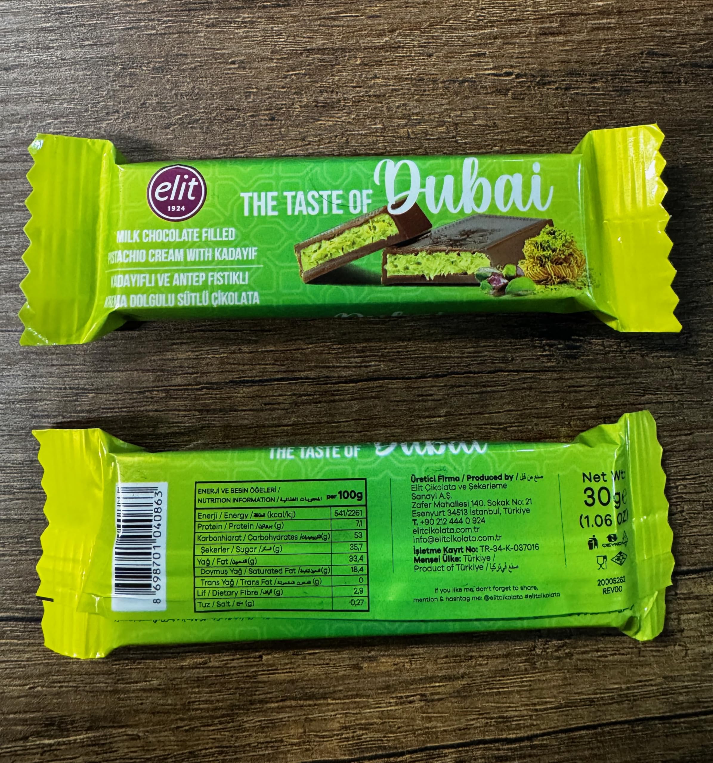 UNIQBITE Mini Dubai Pistachio Bar bar close-up reveals silky milk chocolate for personal indulgence.